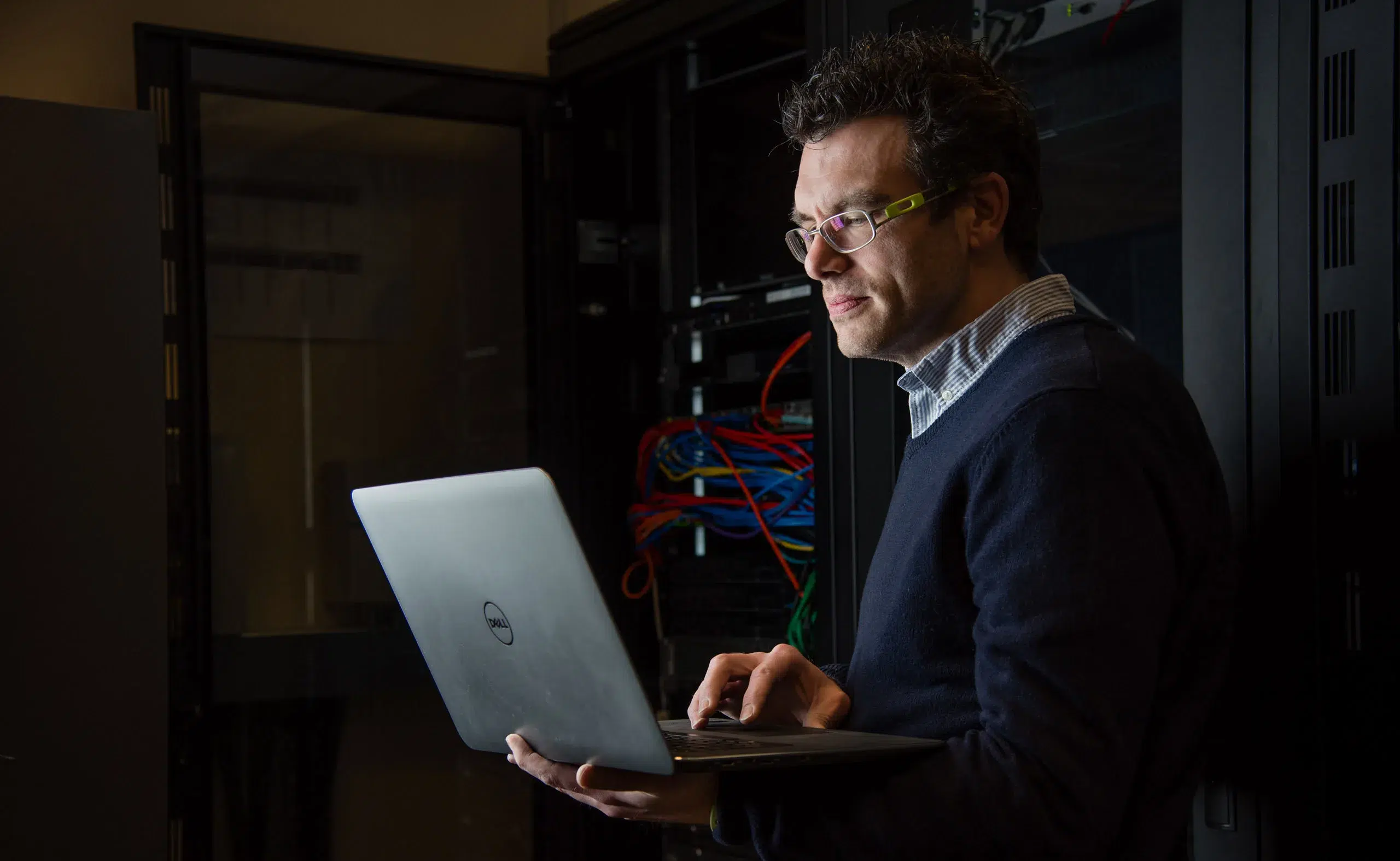 commercial-photography-man-with-laptop-in-data-centre